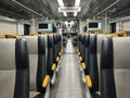 an empty train carriage with rows of seats Royalty Free Stock Photo