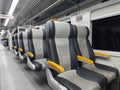 an empty train carriage with rows of seats Royalty Free Stock Photo