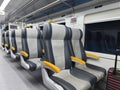 an empty train carriage with rows of seats Royalty Free Stock Photo