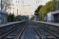 Empty train station, featuring an expanse of tracks that stretch out into the distance