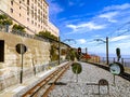Empty train tracks at mountain station under clear blue sky Royalty Free Stock Photo