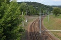 Empty tramway rail tracks, with green trees and grass around. Br Royalty Free Stock Photo