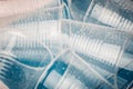 Empty transparent disposable plastic glasses in drops of water on a blue background, macro Royalty Free Stock Photo