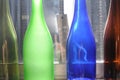 Empty and transparent glass bottles standing in a row, green, blue and brown Royalty Free Stock Photo