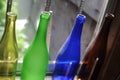 Empty and transparent glass bottles standing in a row, green, blue and brown Royalty Free Stock Photo