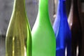 Empty and transparent glass bottles standing in a row, green, blue and brown Royalty Free Stock Photo