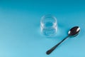 Empty transparent glass jar with metal spoon