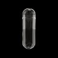 Empty Transparent Medicine Capsule Pill Isolated on Black. Royalty Free Stock Photo