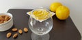 Empty transparent vine glass on brown table near roasted almonds and lemons Royalty Free Stock Photo