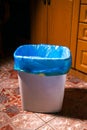 Empty trash bin with blue garbage bag on home kitchen Royalty Free Stock Photo