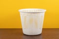 Empty trash, clean garbage bin, plastic basket bin on yellow background Royalty Free Stock Photo
