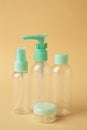 Empty travel cosmetic bottles on beige background. Minimalist bodycare beauty products for vacation or journey. Top view. Royalty Free Stock Photo