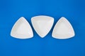 Empty triangular ceramic bowls for sushi on the blue wooden table