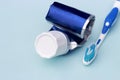 Empty tube of toothpaste and toothbrush on blue background Royalty Free Stock Photo