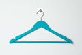 Empty turquoise clothes hanger on white wall Royalty Free Stock Photo