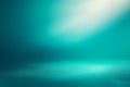 Empty turquoise studio room with spotlight creating gradient background, perfect for product placement Royalty Free Stock Photo