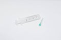 Empty twenty milliliter syringe and a needle on white background. Medicine, treatments and healthcare. Medical concept.