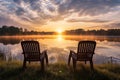 empty twin chairs facing calm lake during sunrise Royalty Free Stock Photo