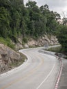 Empty twisting road up hill. Copy space provided.