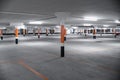 Empty underground car parking lot in Europe. Wide-angle view, neon lights, no people Royalty Free Stock Photo