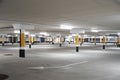 Empty underground car parking lot in Europe. Wide-angle view, neon lights, no people Royalty Free Stock Photo