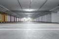 Empty underground car parking lot in Europe. Wide-angle view, neon lights, no people Royalty Free Stock Photo