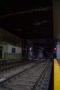 Empty underground train tunnel. Dark subway station.