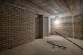 Empty unfurnished basement room with minimal preparatory repairs. interior with white brick walls Royalty Free Stock Photo
