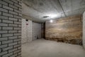 Empty unfurnished basement room with minimal preparatory repairs. interior with white brick walls Royalty Free Stock Photo