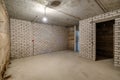 Empty unfurnished basement room with minimal preparatory repairs. interior with white brick walls Royalty Free Stock Photo