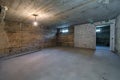 Empty unfurnished basement room with minimal preparatory repairs. interior with white brick walls Royalty Free Stock Photo