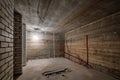 Empty unfurnished basement room with minimal preparatory repairs. interior with white brick walls Royalty Free Stock Photo