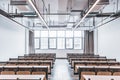 Empty university classrooms and desks and chairs