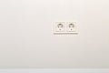 Empty, unplugged european wall outlet on white plaster wall Royalty Free Stock Photo