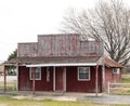 Empty unused abandoned deteriorated red wooden building