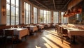 Empty upscale restaurant interior bathed in sunlight. Tables set for dining with white tablecloths, glasses, chairs. Modern decor Royalty Free Stock Photo