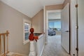 Empty upstairs hallway interior with light pink walls