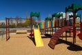 Empty urban residential infrastructure, nobody - children`s playground next to a condominium. Swing, slide, stairs, multistory