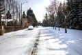 Empty Urban Road Covered in Snow on a Cold Sunny Winter Day Royalty Free Stock Photo