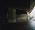 Empty urban underpass in rough concrete and wet asphalt a rainy day Royalty Free Stock Photo