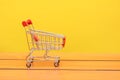 Empty used shopping trolley photo on Wooden board backgorund Royalty Free Stock Photo