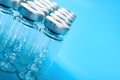 Empty vaccine bottles on a blue background with copy space Royalty Free Stock Photo