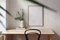 Empty vertical picture frame mockup. Wooden desk, table. Vase with olive branches, magazines. Elegant working space