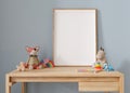 Empty vertical picture frame standing on the desk in modern child room. Frame mock up in contemporary style. Free, copy