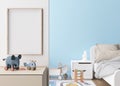 Empty vertical picture frame on white wall in modern child room. Mock up interior in contemporary, scandinavian style Royalty Free Stock Photo