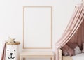 Empty vertical picture frame on white wall in modern child room. Mock up interior in scandinavian style. Free, copy