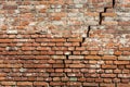 Aged Elegance: Distressed Red Brick Wall Texture with Cracks