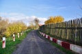 Empty village road among traditional wooden fence Royalty Free Stock Photo