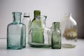 The Empty vintage apothecary bottles at the window