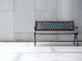Empty vintage bench chair seat with wood and black wrought iron materials, decorated on concrete tiles floors. Royalty Free Stock Photo